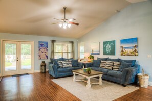The newly decorated spacious living room with a sofa you won't want to leave.