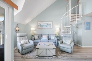 Lofted comfort meets coastal charm in this cozy beach getaway