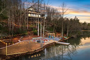 A serene lakeside retreat: Experience tranquility at this charming short-term rental, nestled amidst whispering woods with a private dock and playful outdoor amenities, promising a perfect escape into nature's embrace.