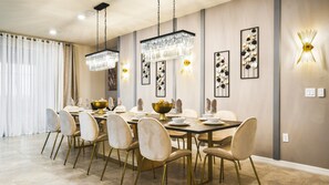 This dining room featuring a long table with 12 seats.