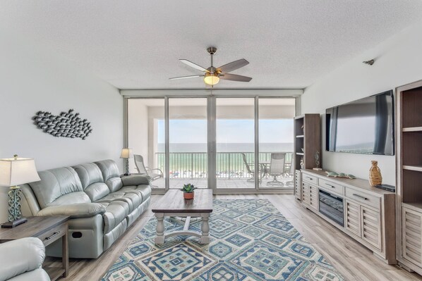 Spacious living area with balcony access and reclining couch