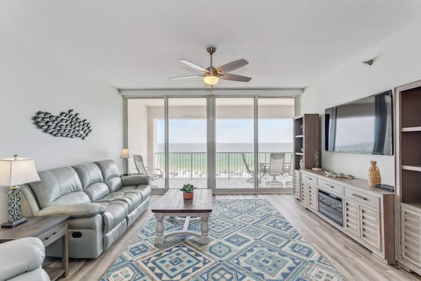 Spacious living area with balcony access and reclining couch