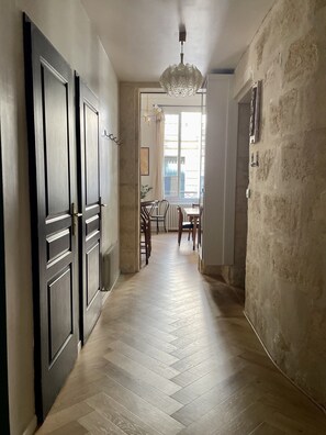 Hallway leading from the living room into the kitchen. Bathroom is on the left.