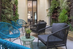 Outdoor private courtyard with table and chairs for the perfect al fresco drink