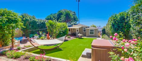 Beautiful, zen shared backyard with hot tub, hammocks, lounge chairs, dining tables, fire pit, outdoor shower and meditation cove!