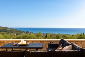 Indulge in the beauty of nature from this stunning veranda with sweeping sea views.