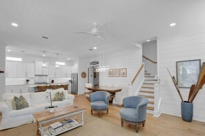 Main Living Space with Kitchen & Dining – Open Staircase Layout - The main floor connects everything—kitchen, dining, living, and a clean line to the upstairs bedrooms. It’s open, airy, and laid out for real-life together time.