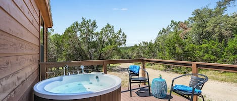 Outdoor jetted bathtub on the front deck.