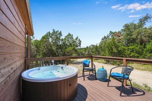 Outdoor jetted bathtub on the front deck.