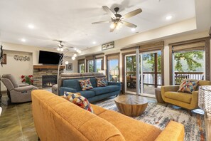 Cozy and spacious living area with TV and fireplace