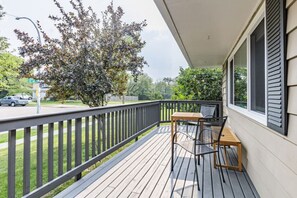 A south facing, sunny wooden deck - ravine entrance visible in the background