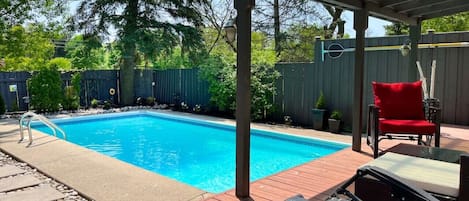 Lounge at our sunny pool. Our yard faces a field so you'll have extra privacy.