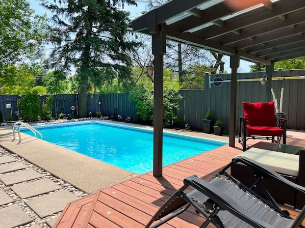 Lounge at our sunny pool. Our yard faces a field so you'll have extra privacy.