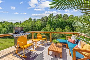 Inviting outdoor patio with colorful furniture and BBQ grill 