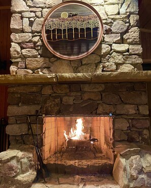 On a cold night, cozy up by the wood burning fireplace