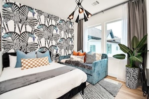 The striking Zebra room features a queen sized bed and a twin sized daybed with memory foam mattresses in an elaborate composition of stripe patterns and complimentary hues.