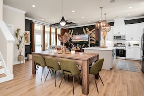 The large shared living space was designed to radiate the chill energy of Tulum with its upscale furnishings and fixtures. The living area features a roomy dining room table, fully stocked kitchen, and a comfy couch to stream all your favorite shows