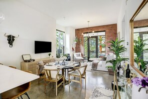 Modern Austin Loft with sleek design & city views. Enjoy floor-to-ceiling windows and stylish brick walls, just 2 miles from the downtown action. 