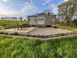 The hut sits in a 2 acre recently planted orchard with decking and dining area
