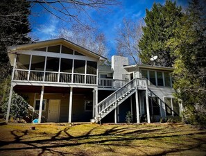 Screened in porch to the left, sun room to the right. Grill on deck in between.