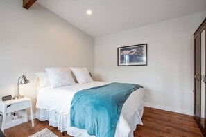 Luxury queen mattress with freshly washed sheets and blankets.