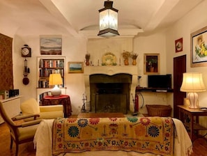 Living room with historical stone fireplace