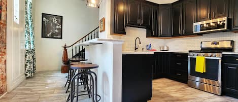 Updated and well-stocked kitchen with an oversized sink and dishwasher.