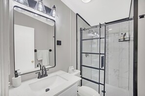 Shared hallway bathroom stocked with all necessities- shampoo, conditioner, soap