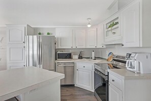 Updated appliances and fully stocked kitchen with place settings, utensils for 6