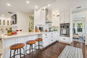 Fully stocked kitchen with breakfast bar.