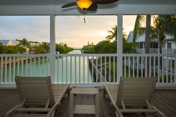 A balcony with water or resort grounds view