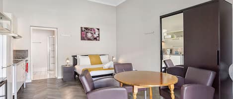 Enjoy meals and conversation at the inviting dining table, surrounded by natural light and a warm ambiance.