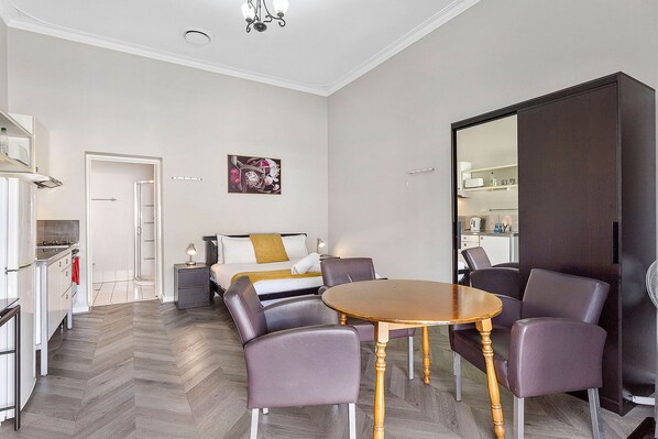 Enjoy meals and conversation at the inviting dining table, surrounded by natural light and a warm ambiance.