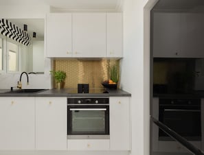 The sleek design of the kitchenette blending seamlessly with the living area.