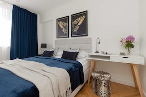 The cosy bedroom features a luxurious double bed and ample storage.