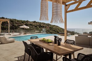Dinning settings, with spectacular sea views, for long culinary gatherings.
