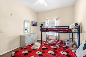 The bunk room feels like its own clubhouse, offering a full-over-full bunk and twin bed with TV