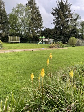 Lush grounds with playground structure.