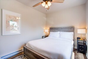Bedroom with Queen bed, two nightstands, closet and dresser.