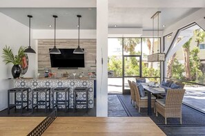 The screened-in living space on the first floor is an extension of the pool-the possibilities for entertainment and relaxation are endless.
