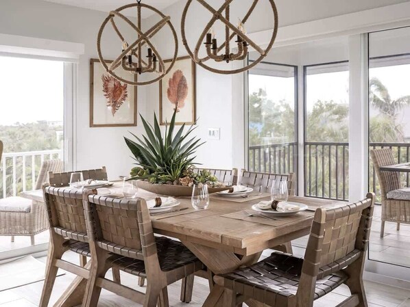 Step into the inviting dining room at Seashell Escape, where coastal elegance meets warm hospitality. This thoughtfully designed space provides a picturesque setting for shared meals, cherished conversations, and unforgettable dining experiences.