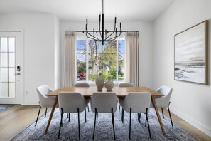 The dining room features stylish décor and a large oak table that seats eight