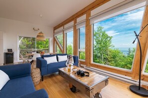 Living room and dining room with large windows and view