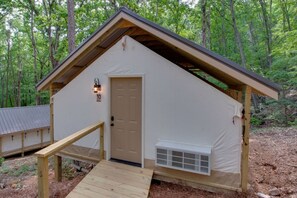 Spacious glamping tent featuring a private hot tub, king bed, and scenic views. Experience luxury camping in the heart of North Alabama.
