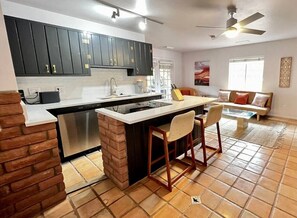 The kitchen area with barstool seating