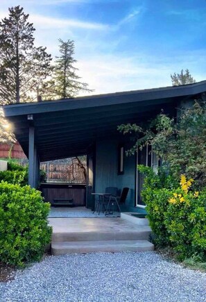 The covered patio has a firepit and hot tub!