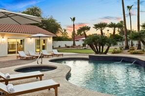 Spacious backyard with pool, hot tub, sport court, putting green, and bocce ball