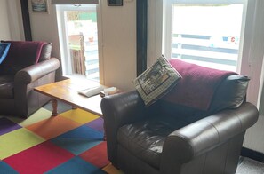 bright and spacious living area, which hosts a log burner ty and dining table