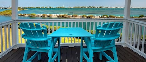 Water views from the balcony with outdoor furniture