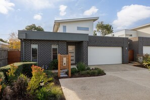 Front of property with extra car spots outside garage